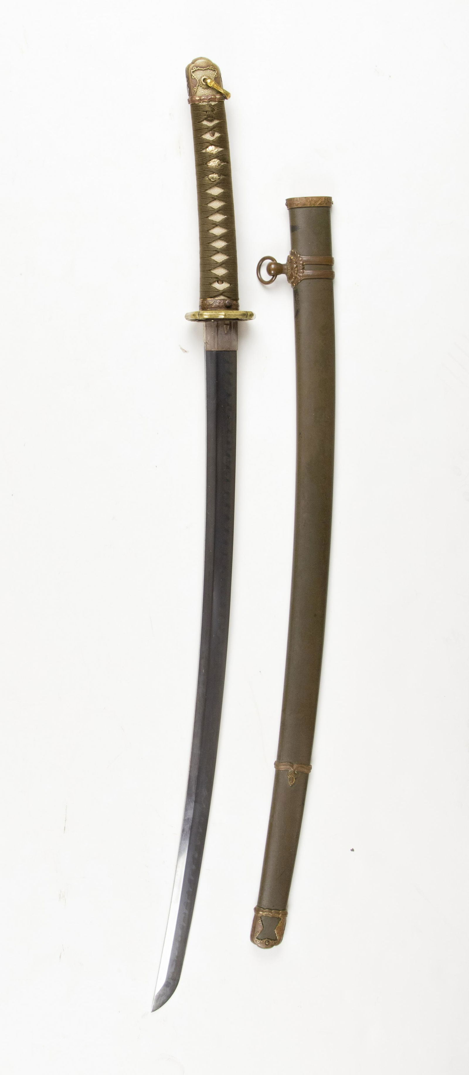 WORLD WAR II JAPANESE OFFICERS KATANA: Finely-forged Japanese officer's sword, a Type 98 Shin Gunto, measuring 27.5 in. from the 'kissaki' (â€˜tip') to the â€˜habaki' (â€˜stop'), and 37 in. overall. The tang is signed â€˜Gu