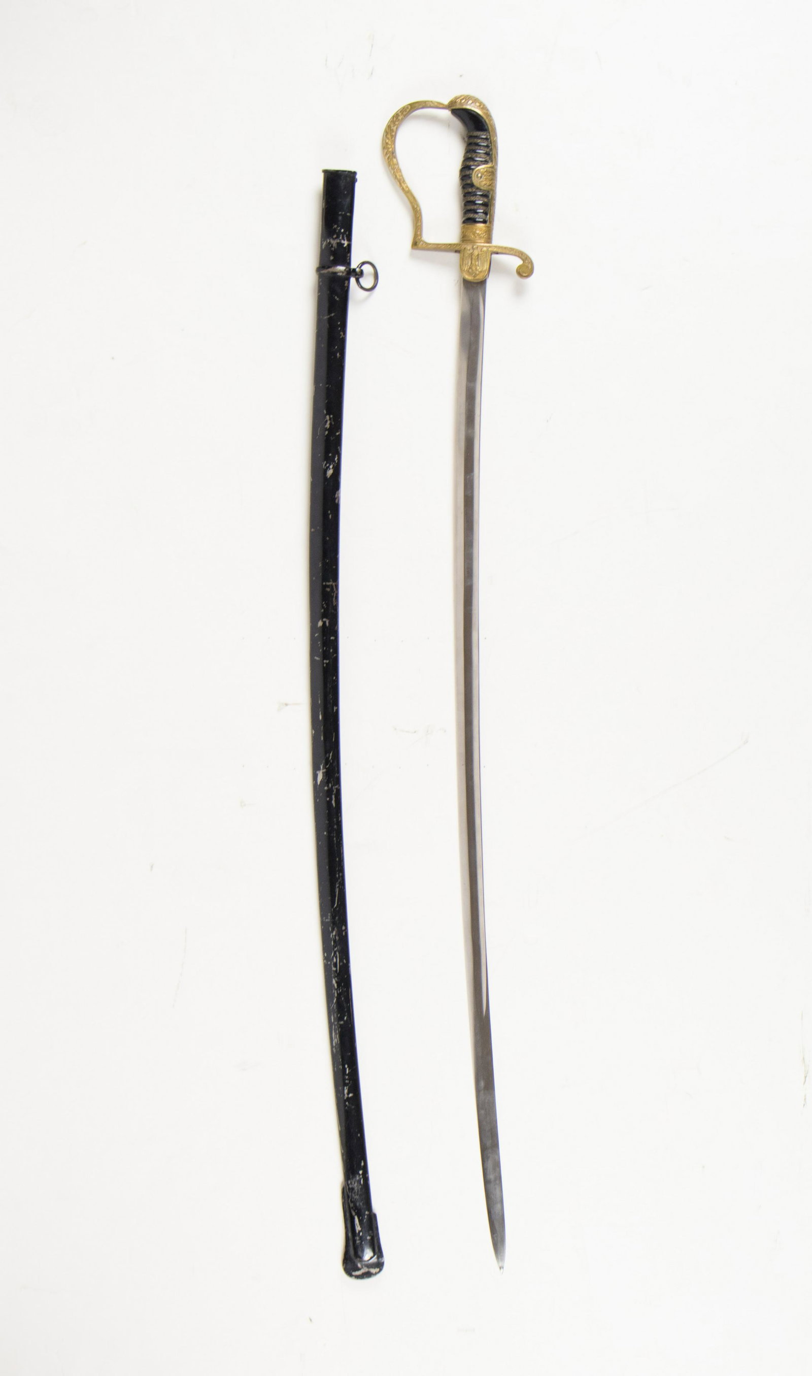 WORLD WAR II HEER OFFICER’S SABER: Fine Third Reich saber, 33 in. blade and 38 in. overall, for use by German Heer officers. This dove head sword features a black celluloid grip tightly wrapped with triple brass wire, the center being 
