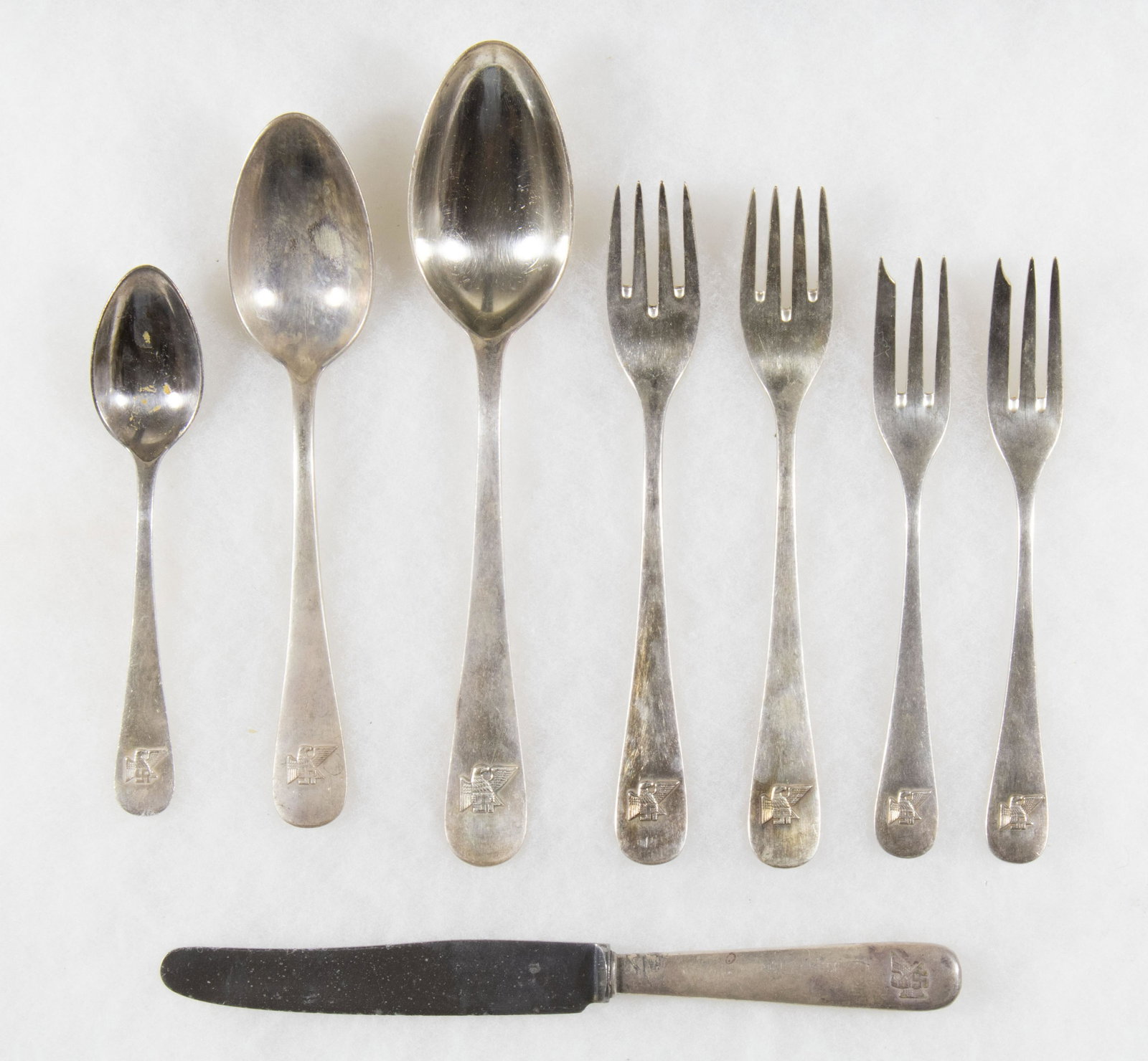 FRITZ SAUCKEL CUTLERY SET (8): A rare set of silver-plated cutlery once owned by the Gauleiter of Thuringia, Fritz Sauckel, varying sizes, comprised a knife, four forks, and three spoons. Each piece bears a 'Thuringia eagle' in rel