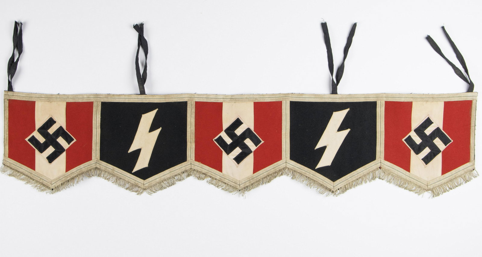 DEUTSCHE JUGVOLK DRUM WRAP: Scarce, well-constructed Deutsche Jungvolk drum wrap, 47 in. long, 9.25 in. tall. The wrap is comprised of five panels - three panels displaying the Hitler Youth emblem of a mobile swastika on a white