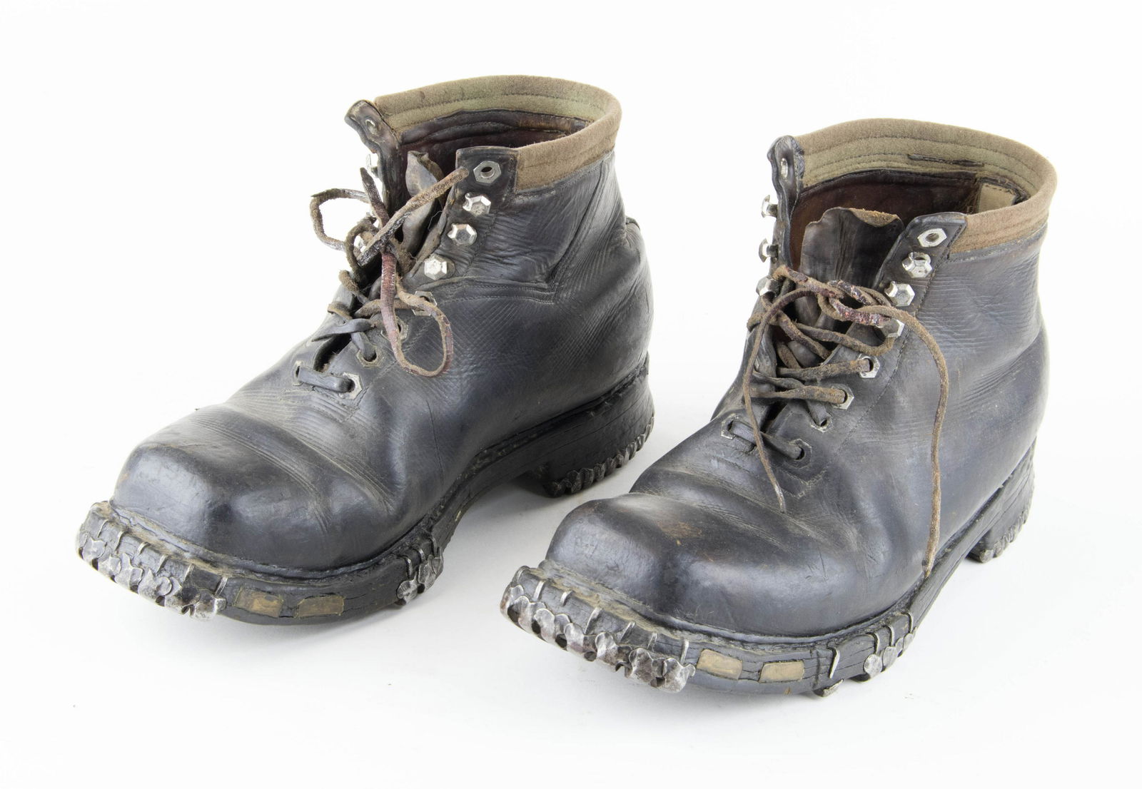 GERMAN ALPINE BOOTS: Pair of brown leather alpine boots with laces, 7 in. tall with 12 in. soles. Each bear steel hobnails on the bottom, distinctive of the boots worn by German alpine soldiers, known as Gebirgsjager. No