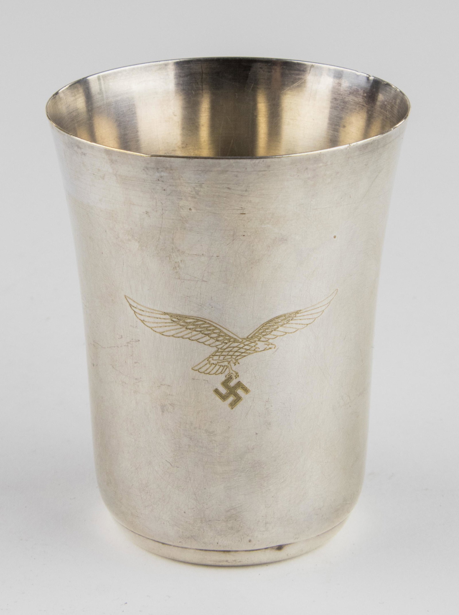 LUFTWAFFE PRESENTATION CUP: Small presentation silver plated Luftwaffe goblet, 3.5 in. tall and hallmarked by WMF, one side engraved with a Luftwaffe and swastika device, the other side engraved: 'F1. P1. - Kdo. Eisenach'. Most 