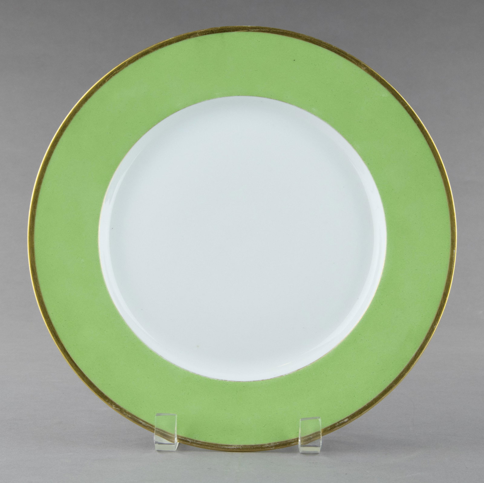 REICHSLEITER PLATE BY NYMPHENBURG: Porcelain plate, 10.25 in. dia., with a light green edge and gold trim. The bottom of the plate displays the underglaze mark of the Nymphenburg Porcelain Manufactory, as well as the insignia of a Reic