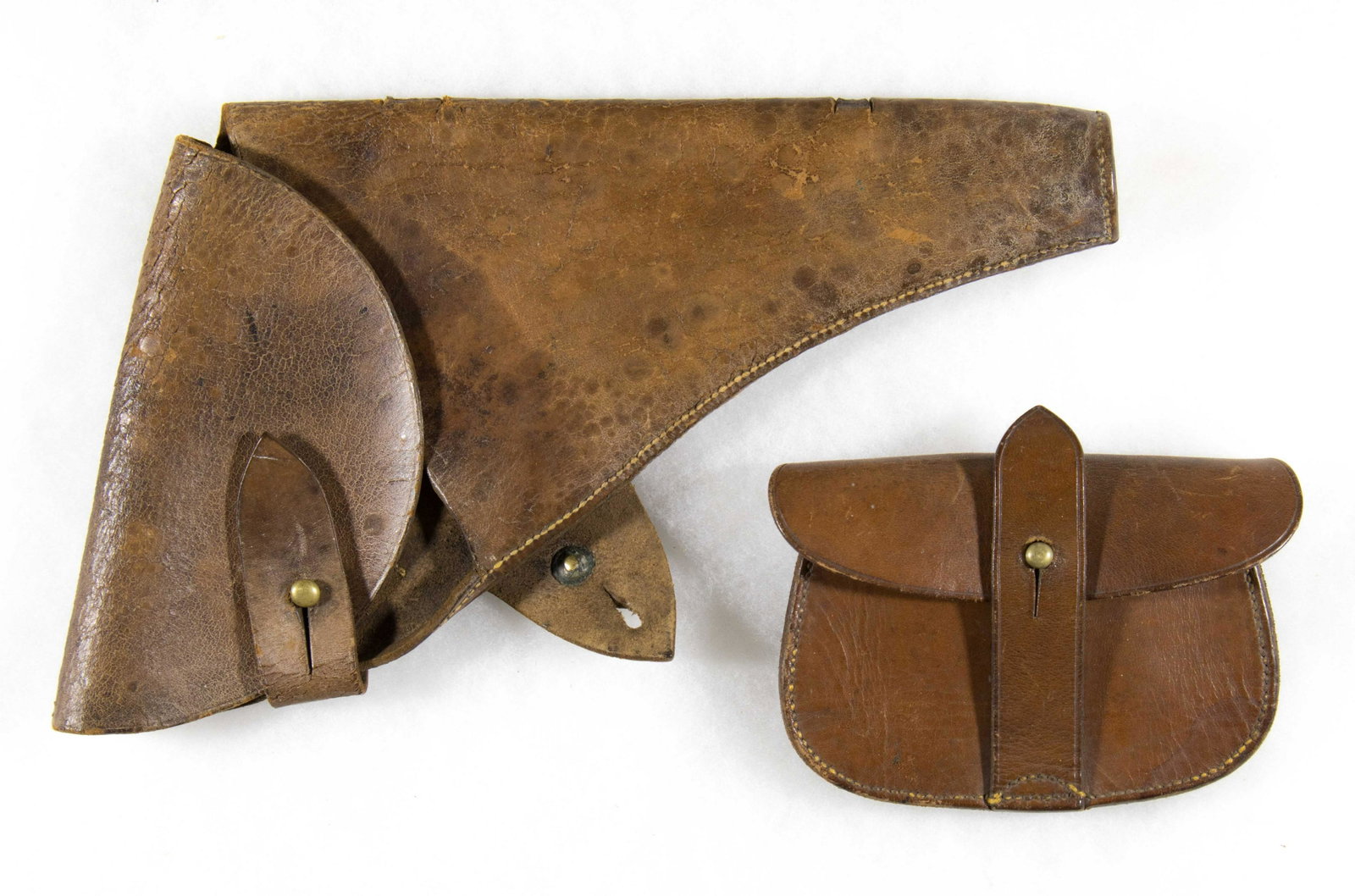 WORLD WAR I WEBLEY MK VI HOLSTER AND AMMO POUCH: Brown leather holster, 6.75 x 12.75 in., for the Webley MK VI revolver, with brass hardware. Maker marked ‘Finnigans Ltd. 1916’ on the reverse belt flap. The leather has cracked throughout