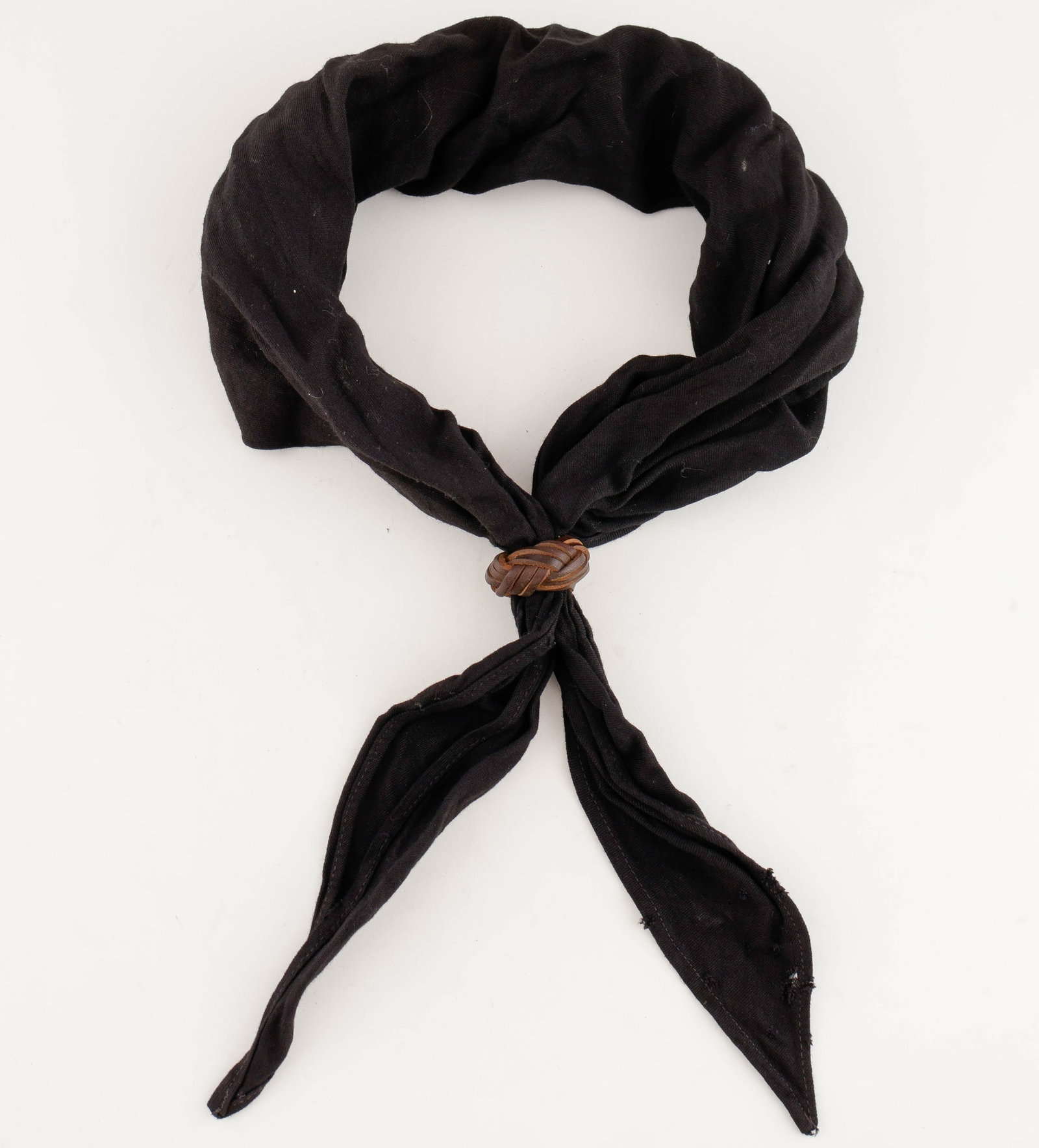 HITLER YOUTH SCARF AND LEATHER KNOT: Hitler Youth black cotton scarf, a few tiny pinholes and some wear along a seam at one place, with the leather scarf knot which is in fine condition.