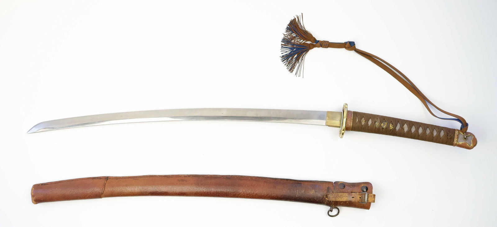 WORLD WAR II JAPANESE OFFICER’S KATANA: Finely-forged Japanese officer's sword, a Type 98 Shin Gunto, measuring 26 in. from the 'kissaki' (‘tip') to the ‘habaki' (‘stop'), and 35.5 in. overall. The tang is signed by the ma