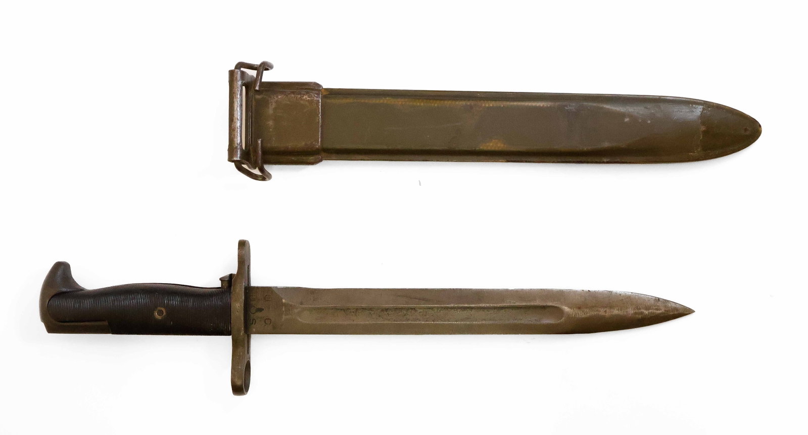 M1 GARAND BAYONET WITH SCABBARD: M1 Garand bayonet, blade 10 in. and 14.5 in. overall with black plastic ribbed handle. The parkerized blade has been stamped on the ricasso by the maker ‘UC’, with Ordnance Dept. emblem. H