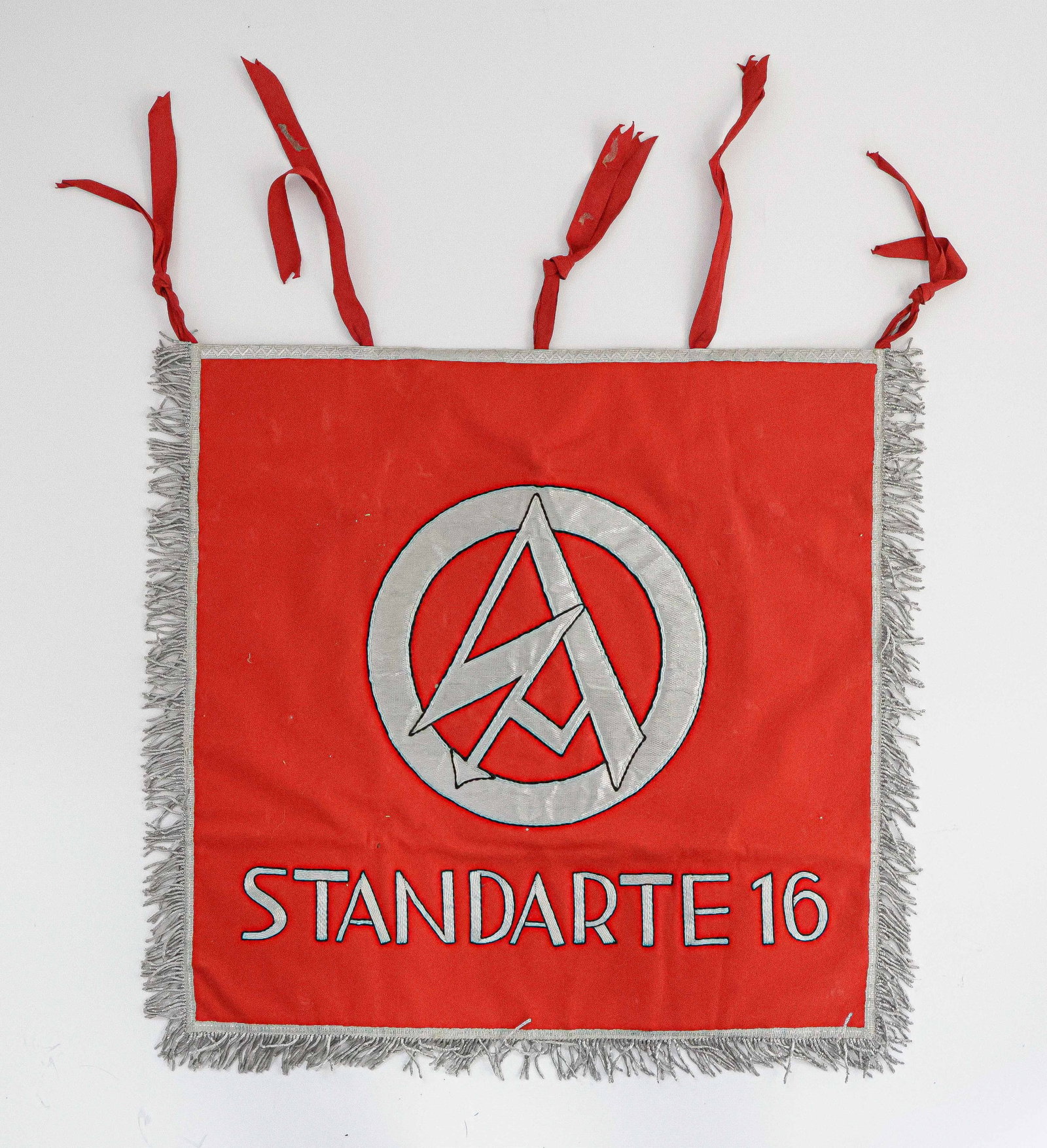 S.A. LANDSHUT STANDARTE TRUMPET BANNER: Double-sided trumpet banner, 20 in. square, the front face featuring a superlative hand-stitched SA emblem in silver bullion, trimmed in black, all against a vivid red background. Reading at the botto