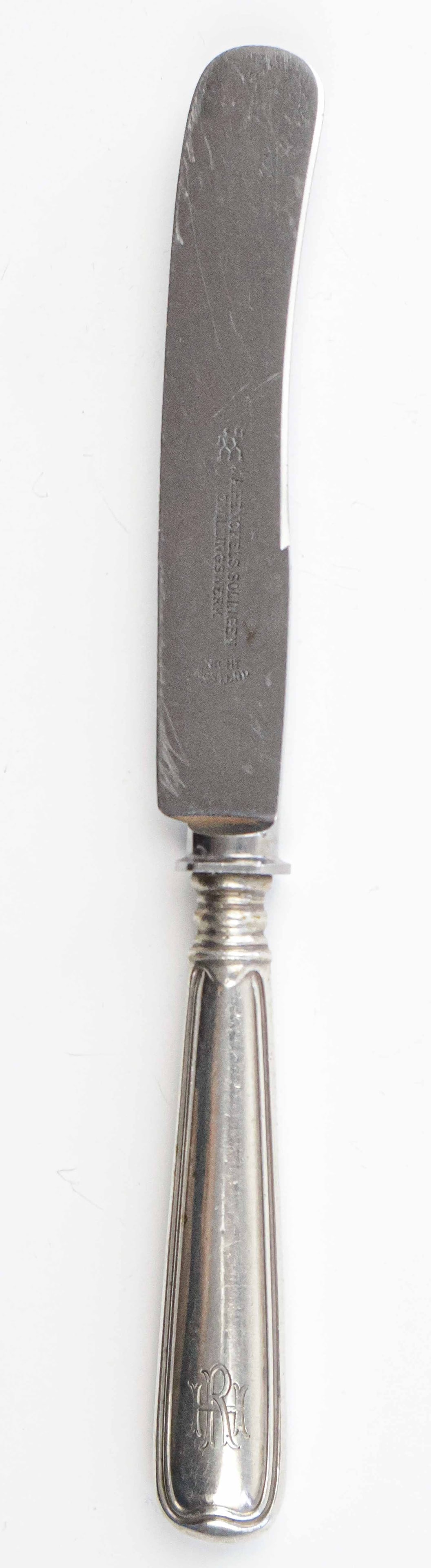 RUDOLF HESS LUNCHEON KNIFE: Silver luncheon knife, 8 in. long, once owned and used by Nazi Party secretary Rudolf Hess. The knife features a simplistic design, though still displays the ornate engraving of his initials ‘R