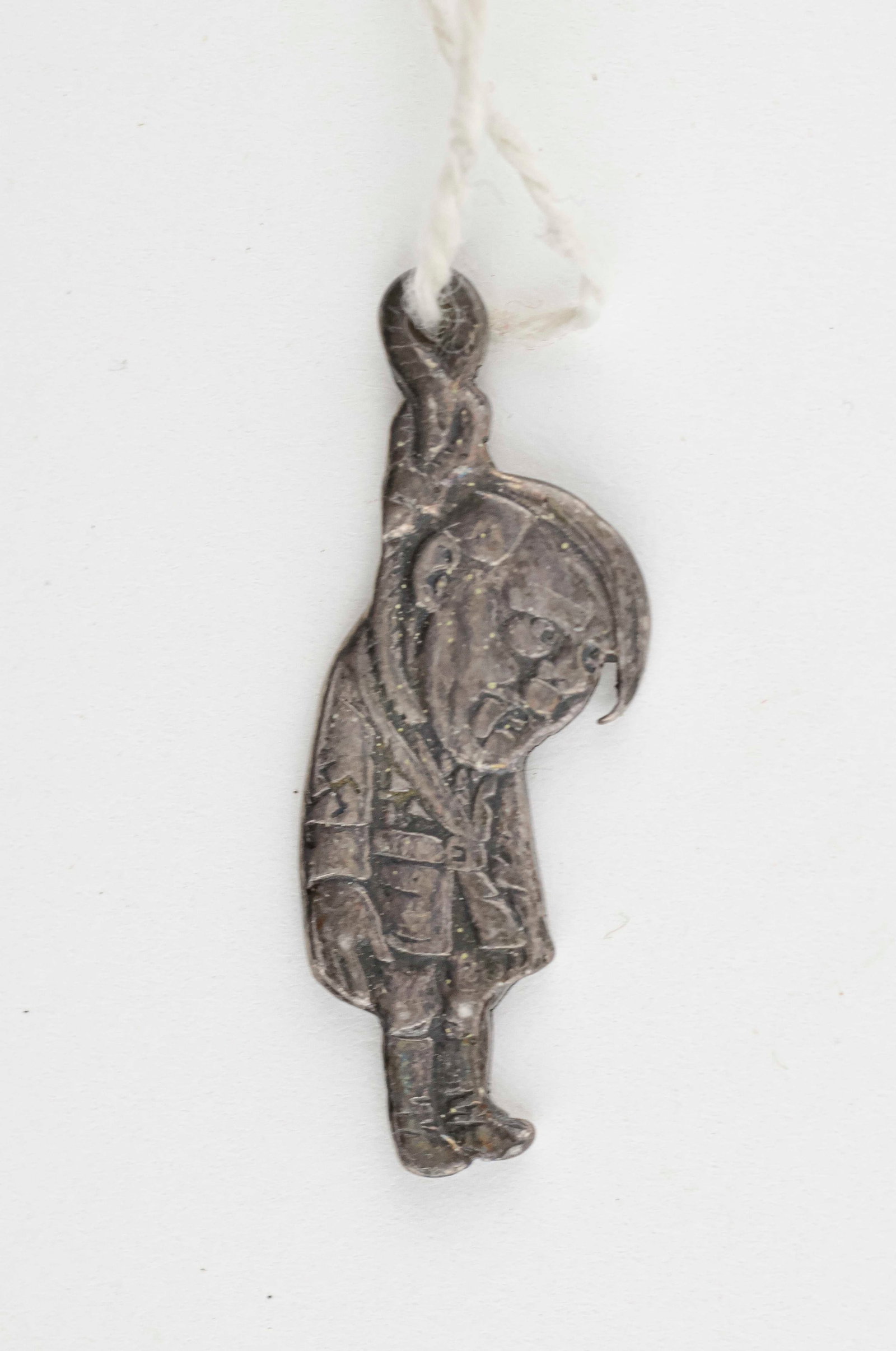 HITLER HANGING FROM NOOSE CHARM: Novelty bracelet charm, 1 in. tall, sterling silver construction, depicting Adolf Hitler hanging from a noose. Exceptionally detailed, showing Hitler in uniform with a swastika on his armband, with hi