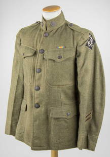 SIBERIAN A.E.F. MACHINE GUNNER'S TUNIC, IDENTIFIED: U.S. Model 1917 green wool tunic issued to a machine gunner attached to the Siberian American Expeditionary Force. The jacket bears the rare black, diamond-shaped 'S AEF' shoulder patch applied to the