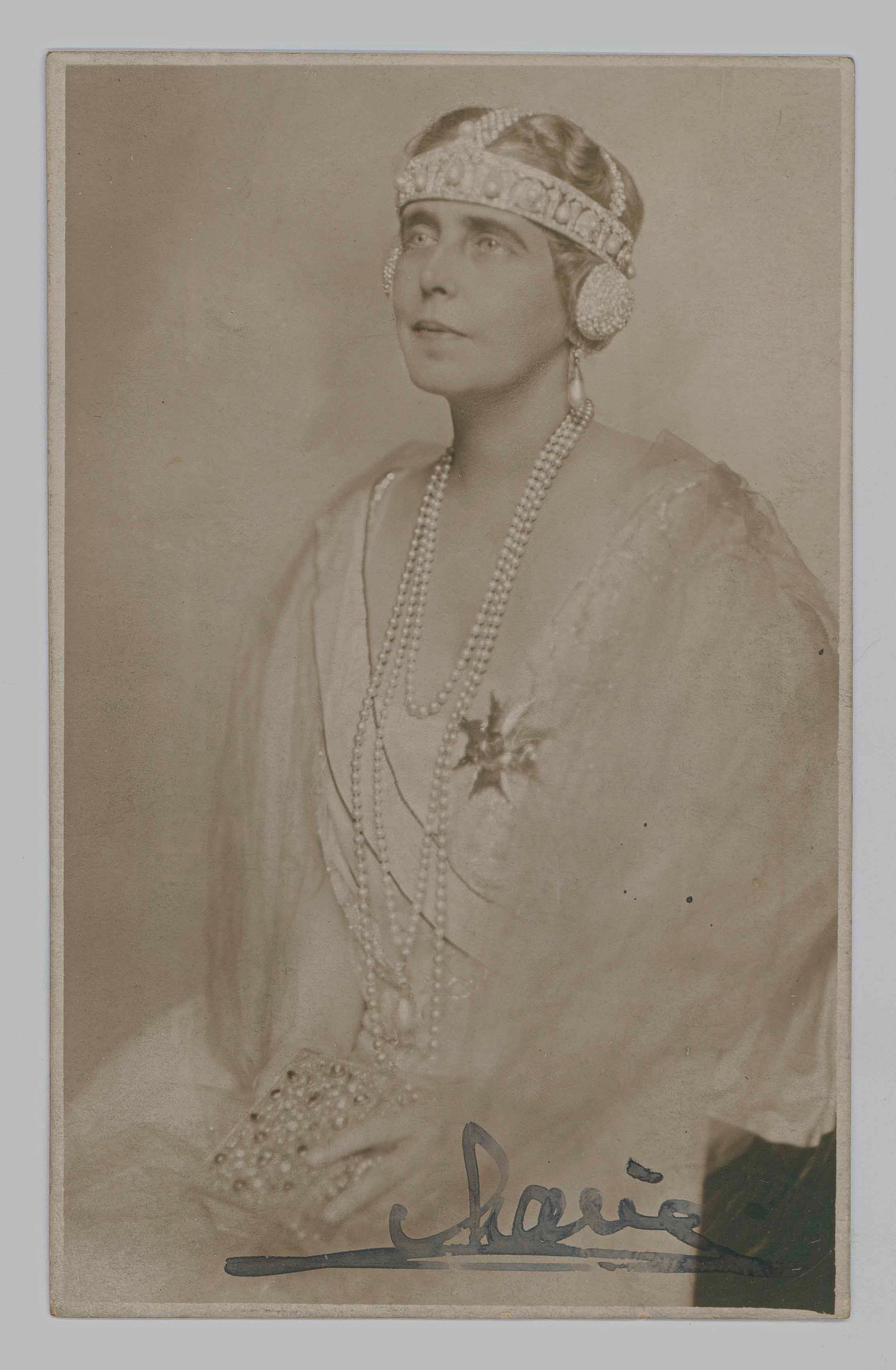 MARIE OF ROMANIA: (1875 -1938) Last Queen consort of Romania as the wife of King Ferdinand I. S.P. 3.25 x 5.25 sepia, a real-photo postcard of the Queen in an elegant 1920s gown, signed on recto. With an A.L.S. in Engl