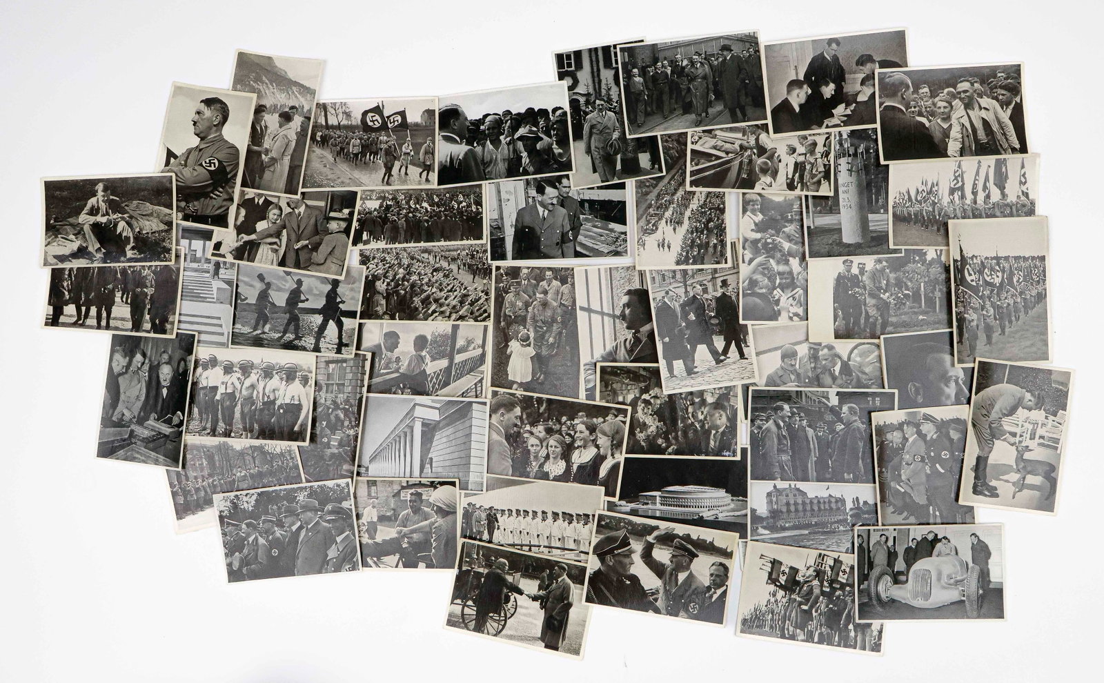 ADOLF HITLER ‘CIGARETTE CARD’ PHOTOS (185+): Extensive collection of approx. 189 Third Reich-era cigarette cards, nearly all 4.5 x 3.5 in. b/w, intended to be collected in the publication ‘Deutschland Erwacht’ (‘Germany Awakened’). The m