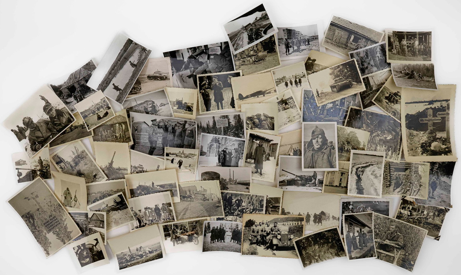 WORLD WAR II EASTERN FRONT PHOTOGRAPH COLLECTION (65+): A collection of original war-date photographs of German soldiers fighting in the Eastern Front, most in small format and with deckled edges and taken in Russia. Images include: Wehrmacht soldiers in R