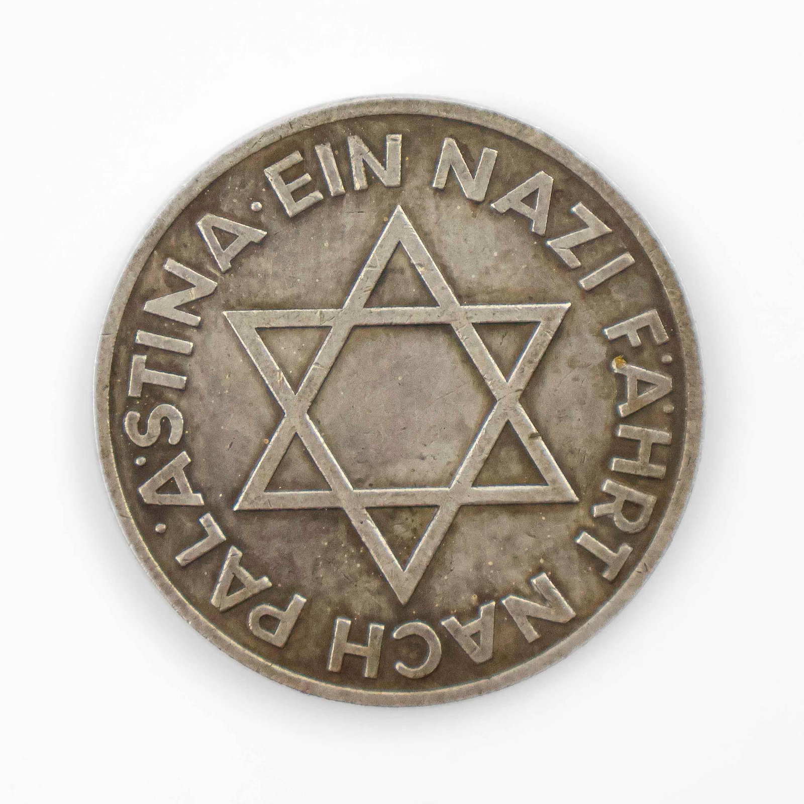 CASED NAZI-ZIONIST COOPERATION MEDAL: ‘A NAZI TRAVELS TO PALESTINE’: Silver medal 1.5 in. diameter, commemorating the unexpected but ultimately doomed attempt at unity between the early Nazi Party and the German Zionist Federation. In the early days of Nazi rule, the Z
