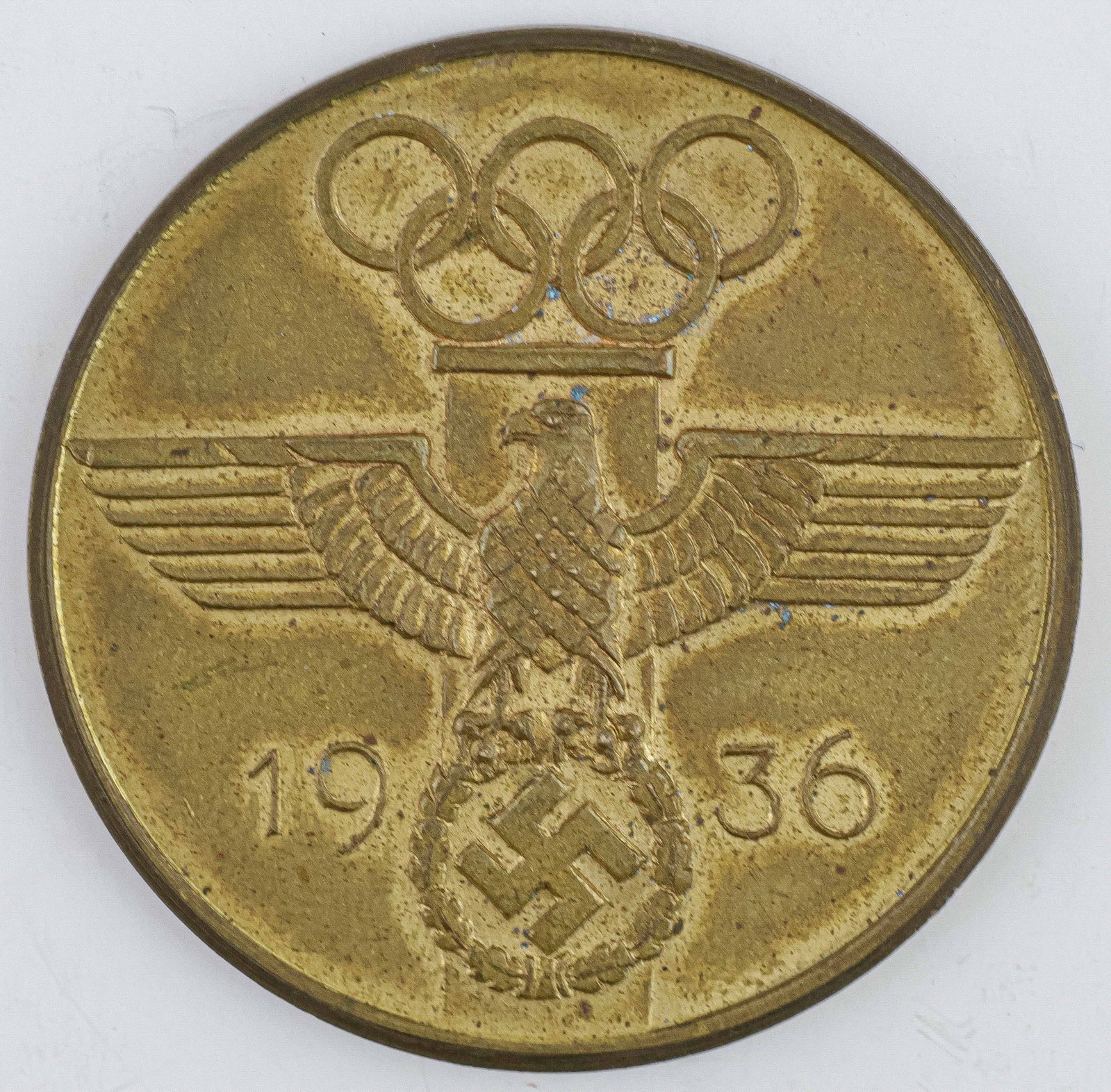 1936 BERLIN OLYMPICS SERVICE MEDAL: A smaller, gilded base metal ‘Service Medal’ awarded at the 1936 Berlin Olympic Games, 1.5 in. diameter, with Olympic rings, German eagle and swastika on obverse, and text on reverse readi