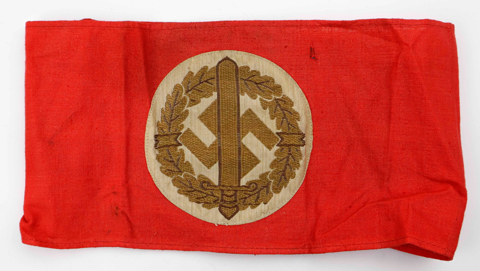 S.A. SPORTS ARMBAND WITH RZM TAG: S.A. Sports red cloth armband, 8.5 x 4.5 in., joined at the back. Sewn at the center is a white round field with an embroidered wreath of oak leaves and an upward-pointing Roman sword at the center, l