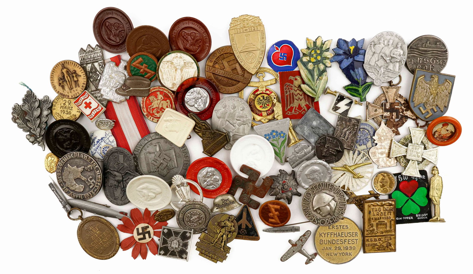 THIRD REICH PINS, INSIGNIA AND TINNIES (60+): A large group of pins and insignia, including two worn medals, WHW tokens of thanks, tinnies, Frauenwerk pins, commemorative badges and many more. Comprises over 60 pieces, in generally good condition