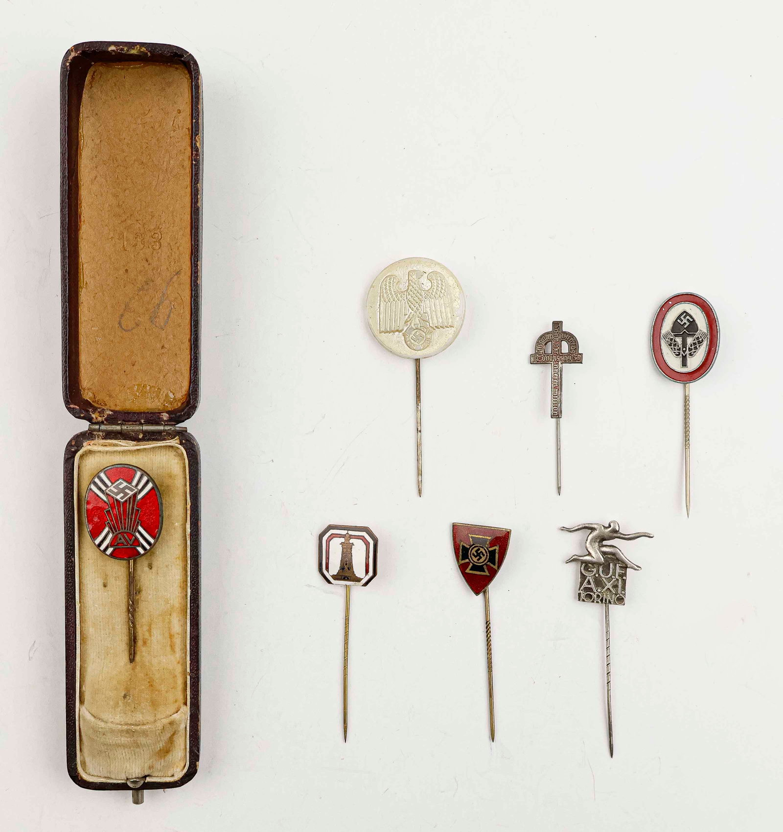 THIRD REICH STICKPIN COLLECTION (7): A lot of seven Nazi stickpins in various materials, one housed in its original velvet coffin case. Good to very good.