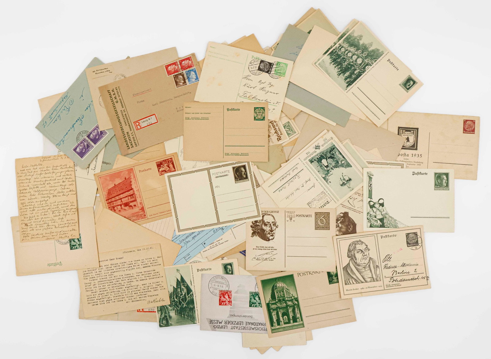 THIRD REICH POSTAL HISTORY (100+): A large group of German World War II era postcards, postal covers and related ephemera dating from the 1930s to 1940s. Includes several postcards of Adolf Hitler, the Winterhilfswerk campaign, the 193