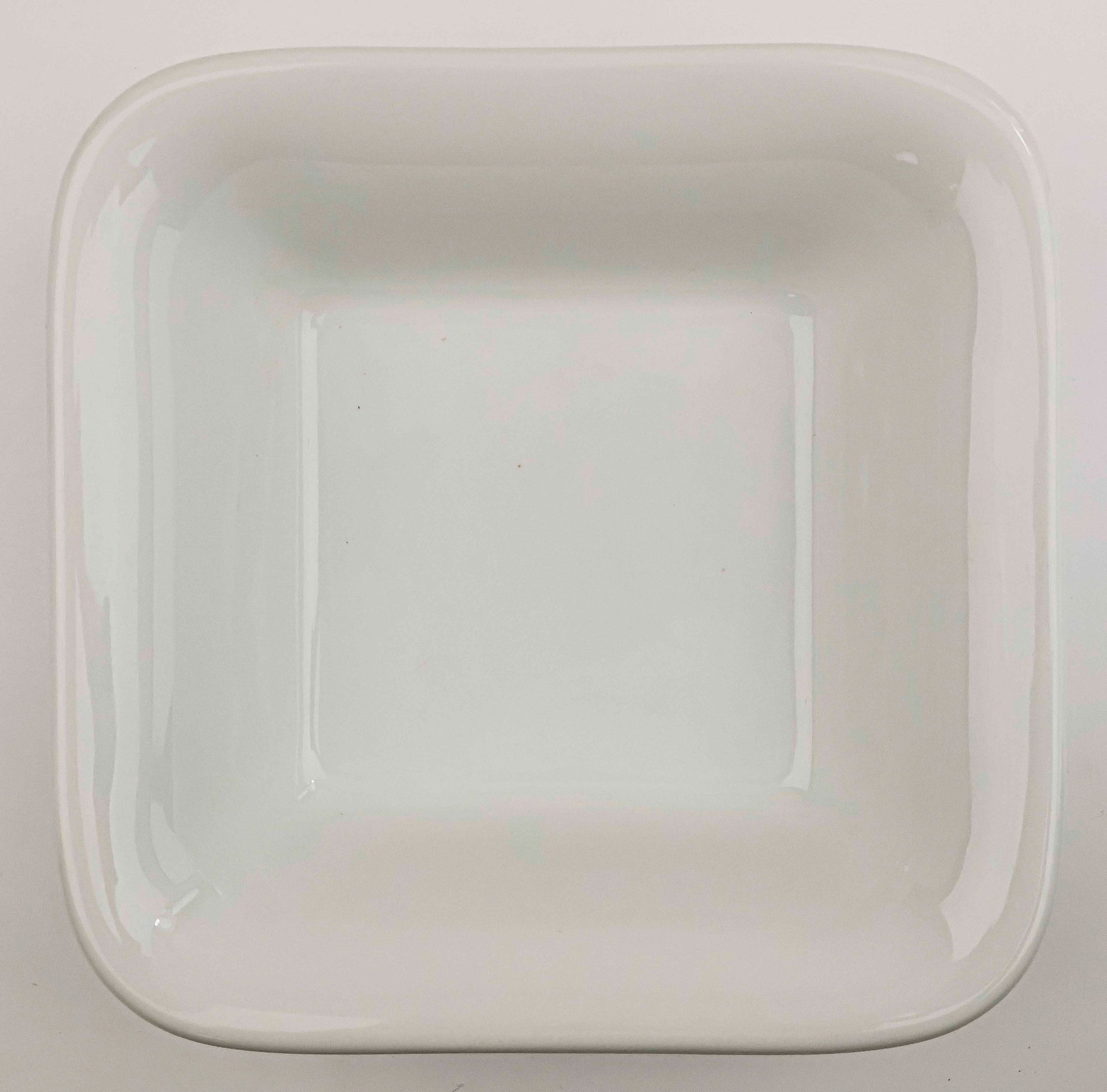 NSDAP SERVING BOWL: Square porcelain serving bowl, 10.5 in. square. Stamped on the base is the German national eagle and swastika along with the maker mark for W. Schonwald of Bavaria. Further date stamped ‘1938
