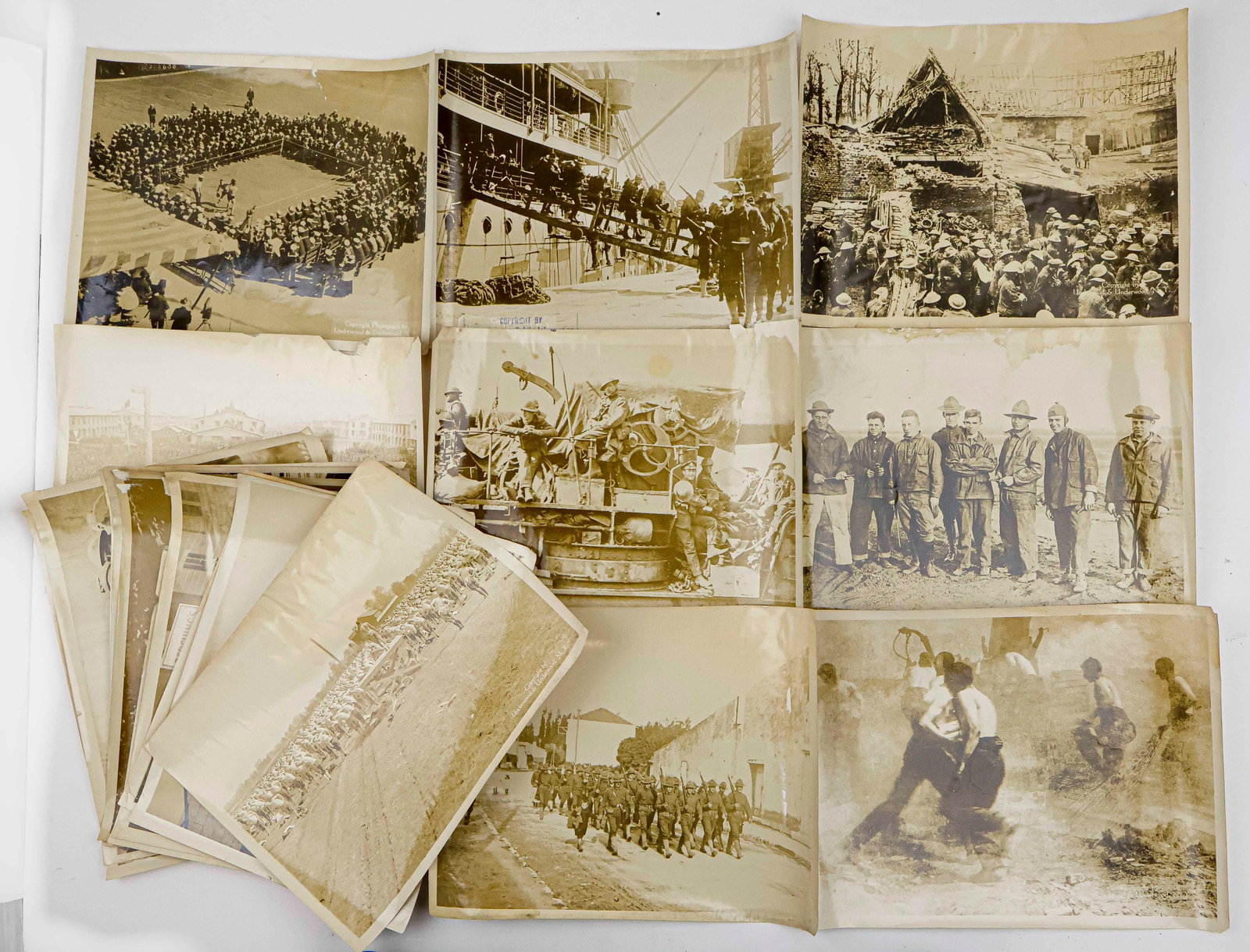 PERIOD OVERSIZED PHOTOGRAPHS OF AMERICANS AT WAR (18): A set of 18 oversized original photographs, each 14 x 11 in., ca. 1918, showing American soldiers and civilians at war during World War I. Images include scenes of soldiers and sailors debarking from 