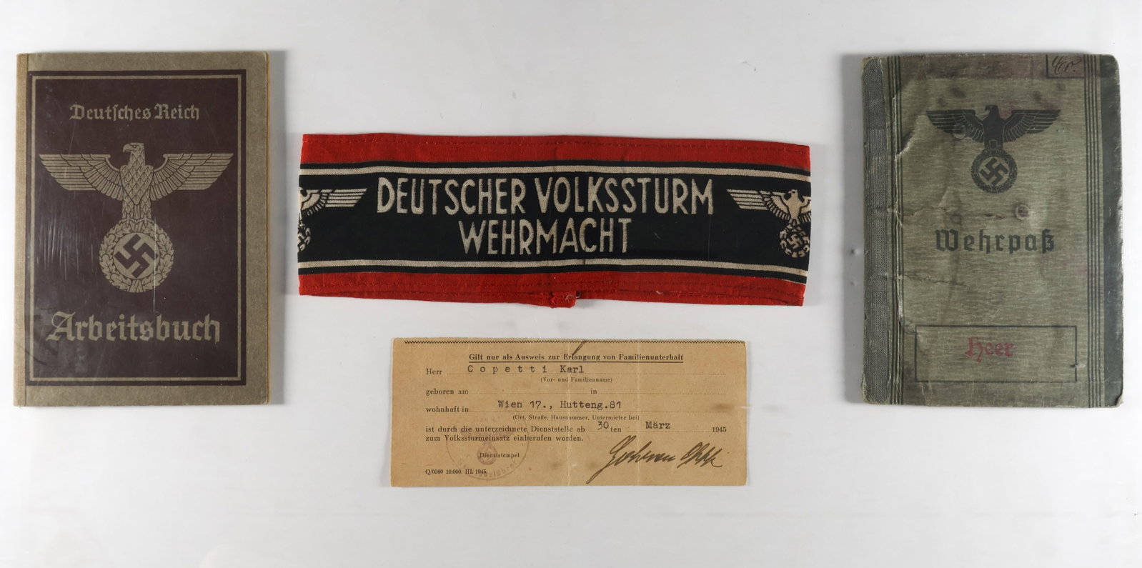 LANDESSCHUTZEN WEHRPASS AND ARMBAND: A rare grouping of items issued to a member of the Landesschutzen in Vienna, essentially Volkssturm troops tasked with fighting partisans and maintaining order. These items were issued to one Karl Cop