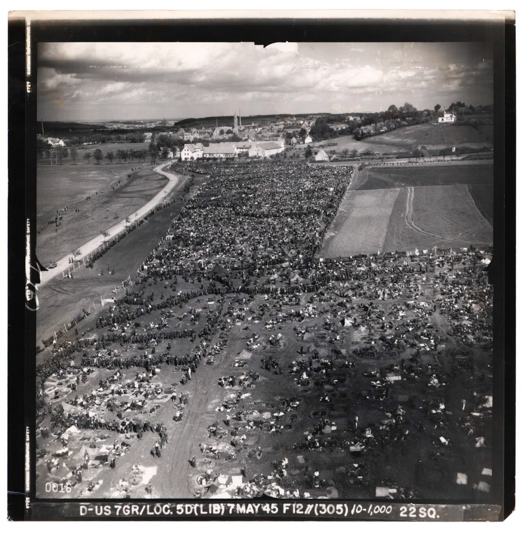 GERMAN P.O.W.S ONE DAY BEFORE GERMANY'S SURRENDER: Terrific original aerial photograph showing thousands of German prisoners held outdoors in a temporary facility on May 7, 1945 - one day before Germany's unconditional surrender. The very detailed pho