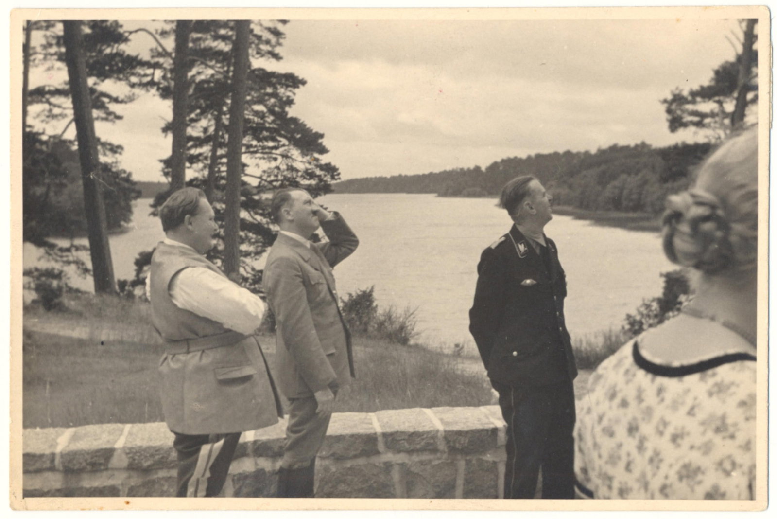 ORIGINAL HITLER, HIMMLER AND GORING PHOTOGRAPH: Original candid photograph, 5.75 x 3.75 in. b/w, an image of Adolf Hitler and Hermann Goring with Heinrich Himmler in uniform, all on a patio near a lake, likely the Tagensee. Printed on 'Agfa Bovira'