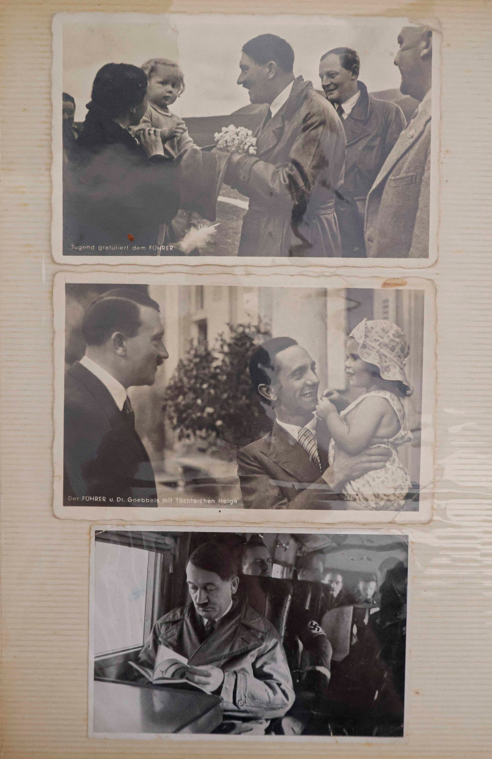 WORLD WAR II HITLER AND GOEBBELS PHOTOS (33): A collection of thirty-three German photos and photo postcards from World War II, presented within a 10 x 11.5 in. photo album. Images include: candid shots of Hitler as he happily greets young civili
