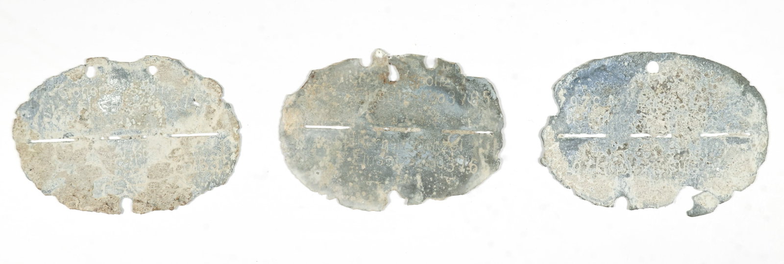 EINSATZGRUPPEN IDENTIFICATION DISCS: Lot of three 'dug' Einsatzgruppen identification discs, quite corroded and only partially cleaned, but all properly identified. The Einsatzgruppen were SS paramilitary death squads that were responsib