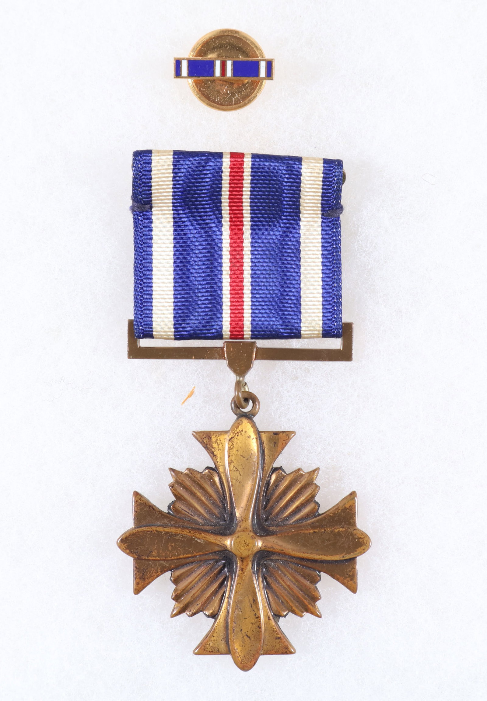 IDENTIFIED DISTINGUISHED FLYING CROSS: An identified World War II Distinguished Flying Cross with ribbon, cased and with lapel insignia, in fine condition. This award is engraved on the reverse: 'Presented to Major Harold M. Rosenthal by L