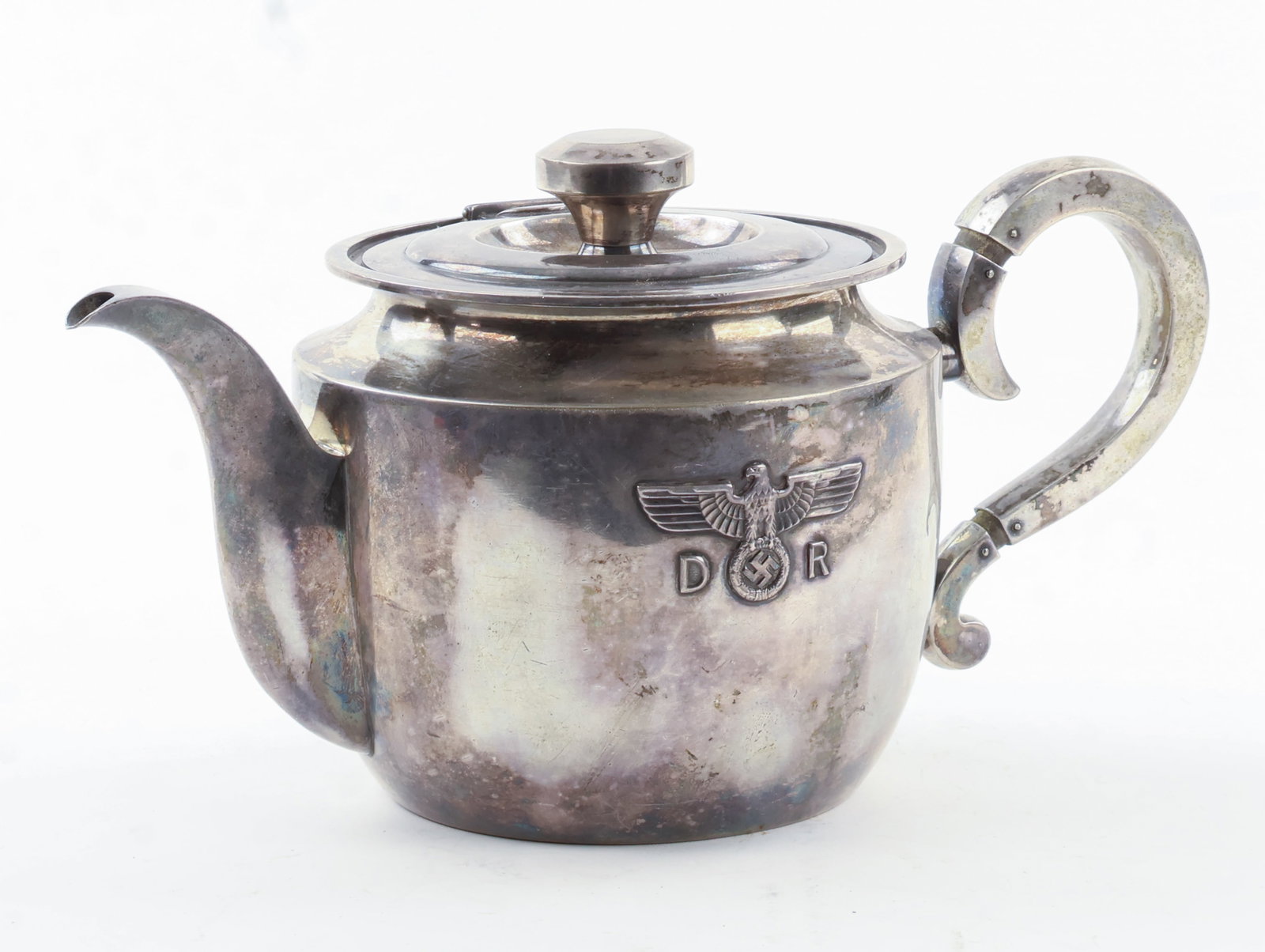 ADOLF HITLERíS COFFEE POT FROM HIS PRIVATE TRAIN: Fine piece of Third Reich tableware, a silver coffee pot, 10 x 6 in., from the ëFuhrersonderzug', Hitler's private train. The front features a raised national eagle and swastika, flanked by the i