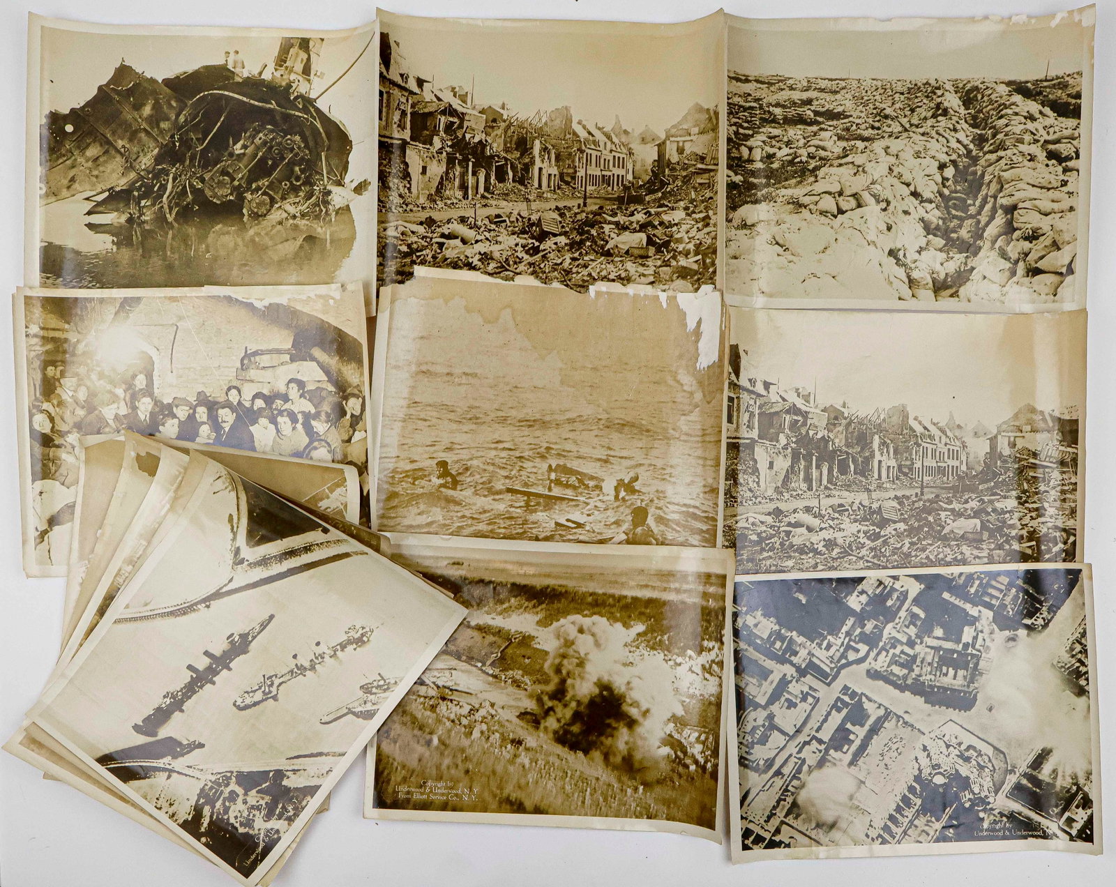 WORLD WAR I DEATH AND DESTRUCTION OVERSIZED PHOTOGRAPHS (13): A set of 13 oversized original photographs, each 14 x 11 in., ca. 1918, showing various scenes of death and destruction during World War I. Images include shattered trenches, destroyed towns and villa