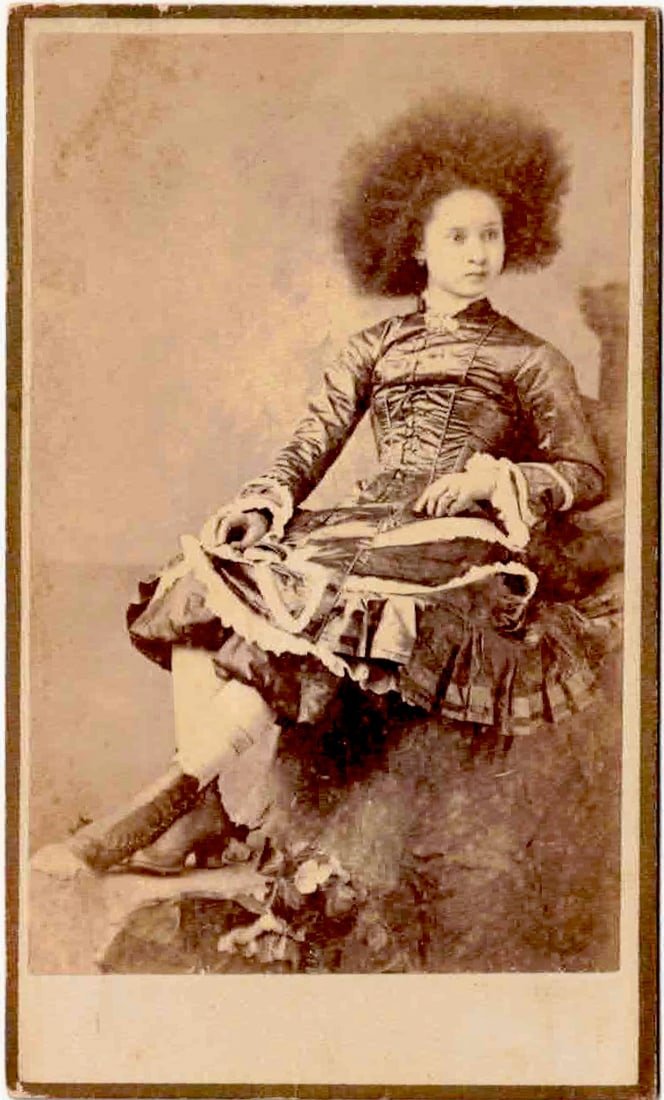 'ZARRNIE ZARROBIA, THE AFRICAN CANNIBAL': Incredible carte de visite photograph picturing a likely mulatto well-dressed young lady, described on the verso in pencil and with a stamp as: 'ZARRNIE ZARROBIA...The African Cannibal...Age 14'. Fine