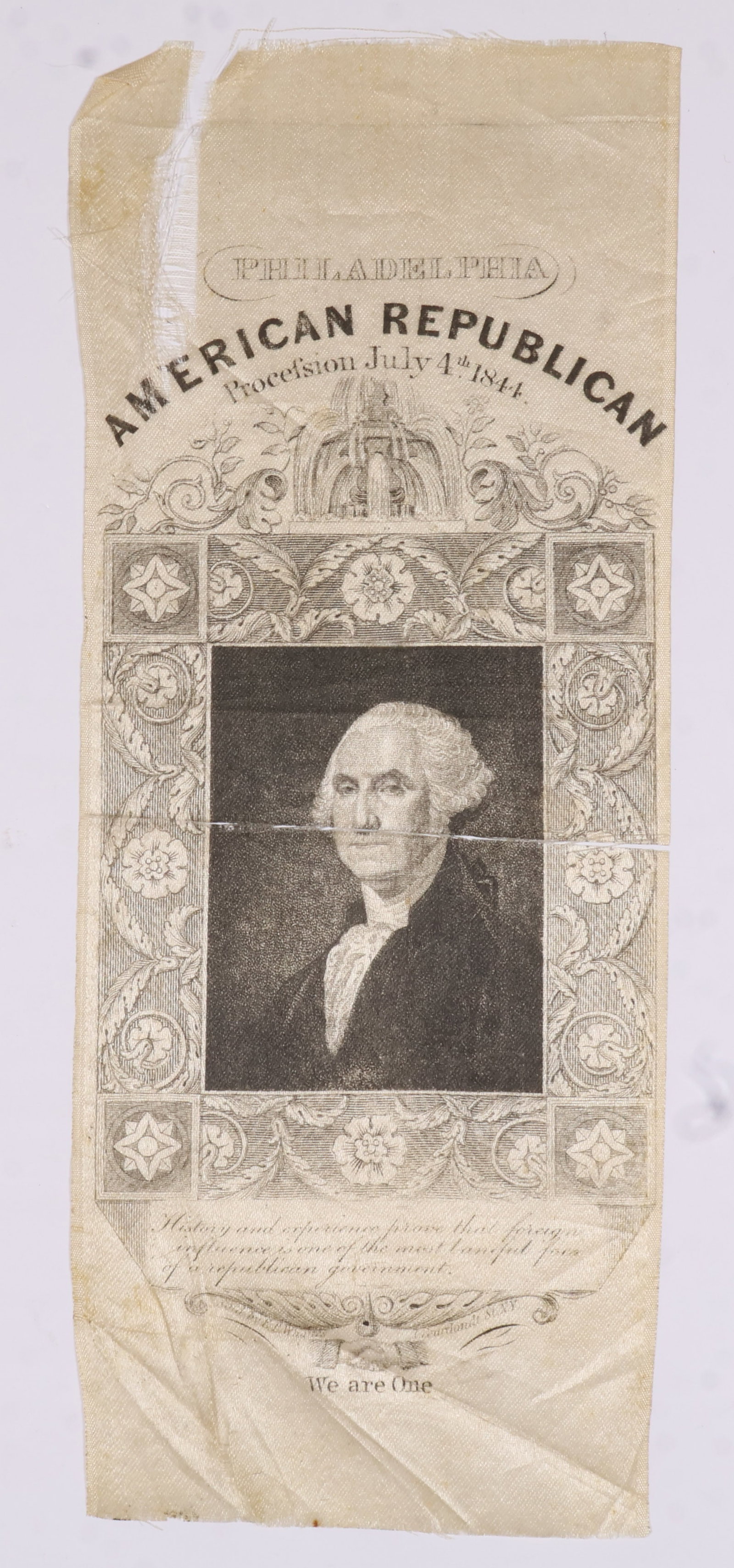 GEORGE WASHINGTON PARADE RIBBON: Rare silk George Washington parade ribbon, 7.25 x 2.75 in., issued in Philadelphia for the 'American Republican Procession July 4th 1844', frayed at the top left and nearly completely split horizontal