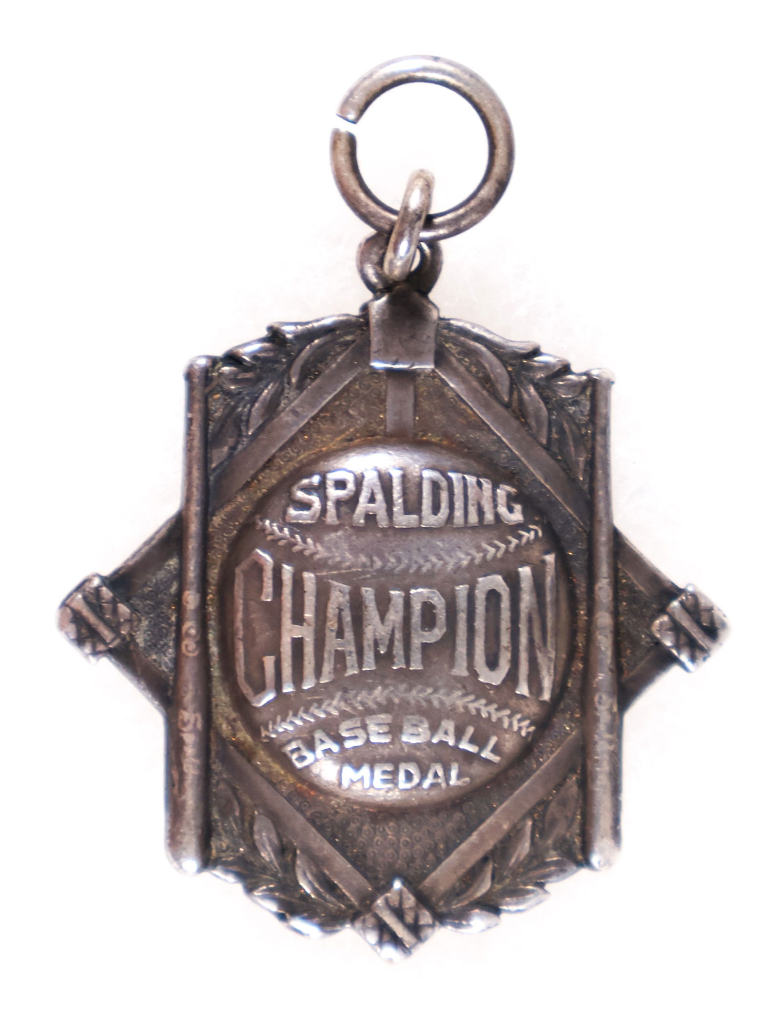 SPALDING CHAMPION BASEBALL MEDAL: Scarce piece of baseball memorabilia, a sterling silver 'Spalding Champion Baseball Medal'. The medal, 1.75 in. tall, bears an image of a baseball on the obverse, superimposed over a baseball diamond