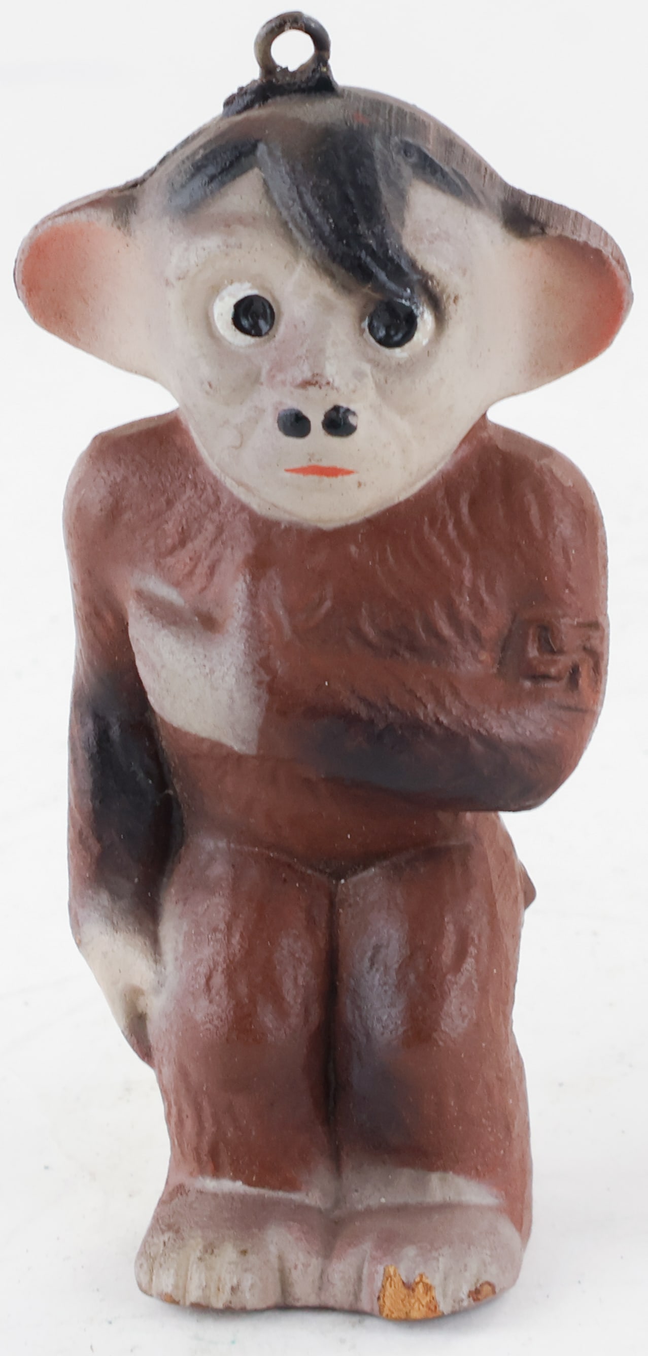 ANTI-HITLER MONKEY FIGURE: A 4.5 x 2 x 1.5 in. Bakelite figure of a monkey with Adolf Hitler’s face and a brown armband. Some missing paint with a hole at the bottom, otherwise fine.