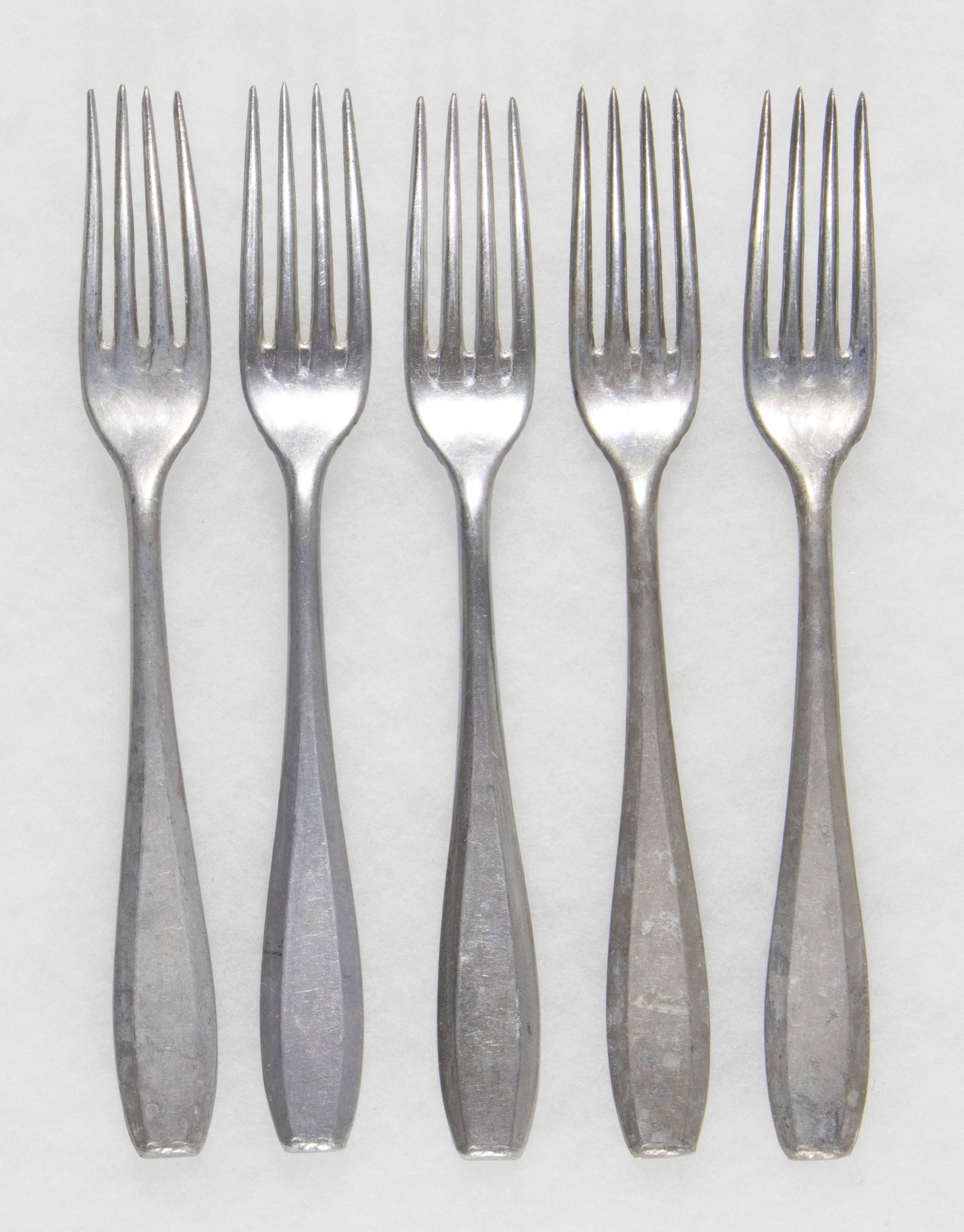WEHRMACHT ISSUE TABLE FORKS (5): Lot of five Wehrmacht aluminum forks, each 8.25 in. long, marked 'W.A.L. 42' and 'UNIAL', with a national eagle. Very good.