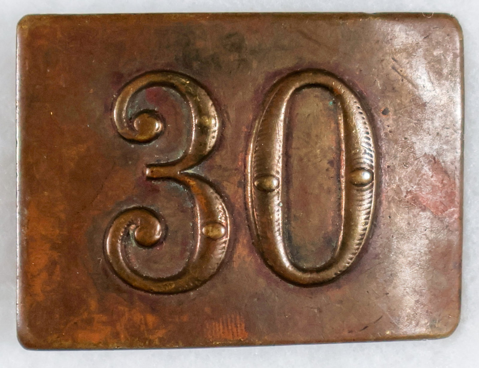 CIVIL WAR REGIMENTAL BELT BUCKLE: A belt buckle, 2.75 x 2 in., made of bronze with a large number ‘30’ embossed on it. This could represent twelve different Union regiments that served under that numerical designation duri