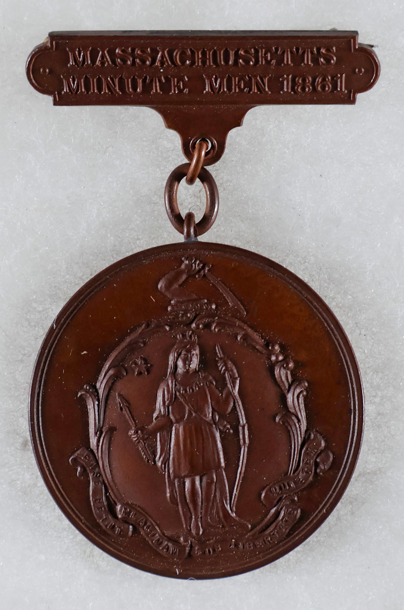 MASSACHUSETTS MINUTEMAN MEDAL: Massachusetts Volunteer Militia Honorary Medal, presented to Pvt. Asa K. Reed of the Mass. 4th Infantry. The obverse of the medal shows the Seal of the Commonwealth of Massachusetts. The reverse bears