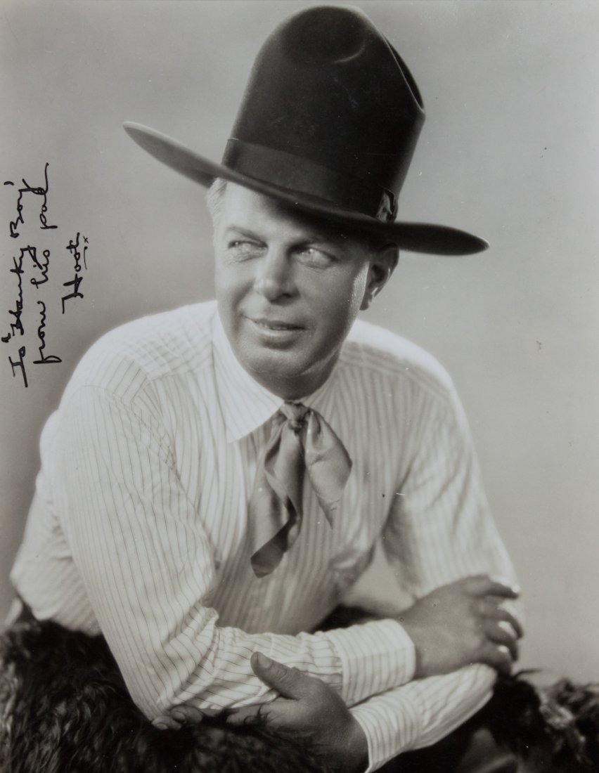 HOOT GIBSON: (1892 - 1962) American film actor, a silent screen star of silent films. Superb vintage I.S.P., 7" x 9 1/4" (sight) b/w, a half-length seated pose in cowboy hat and chaps, signed at left: "To 'Hanky B