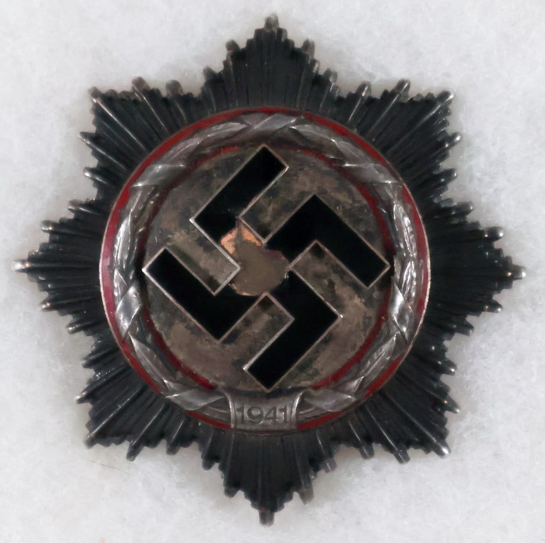 GERMAN CROSS IN SILVER: German Cross in Silver, quite worn with silver about the swastika well tarnished, black enamel upon the swastika heavily chipped and the rays somewhat oxidized. No maker indicated to the reverse, coke