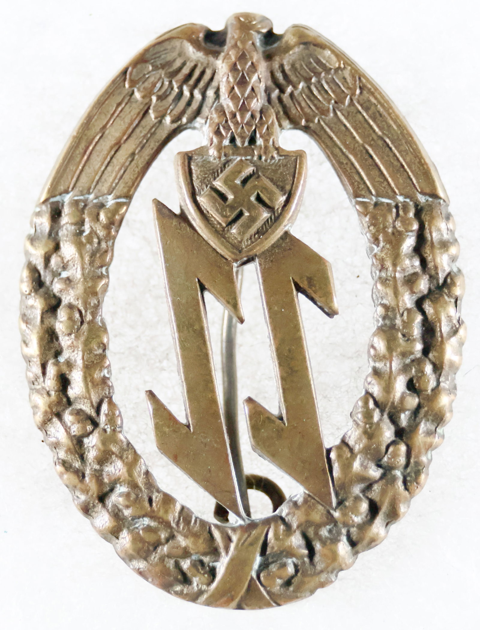 (CROATIA) BADGE OF THE CROATIAN-GERMAN EINSATZSTAFFEL UNITS: Exceedingly rare Badge of the Einsatzstaffel (ES) der Deutschen Mannschaft, in die stamped bronze, with typical Croatian style pin on reverse with bent catch, 1.75 in. long, unmarked, in very fine con