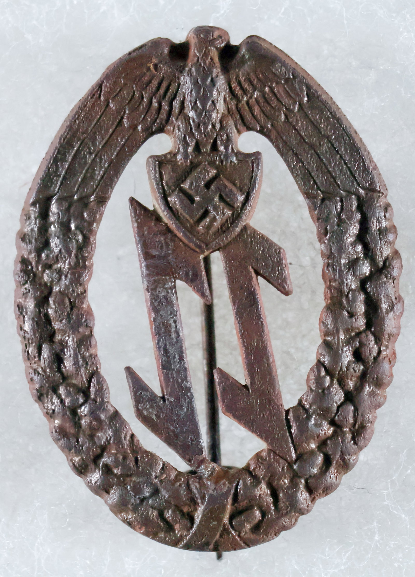 (CROATIA) BADGE OF THE CROATIAN-GERMAN EINSATZSTAFFEL UNITS: Exceedingly rare Badge of the Einsatzstaffel (ES) der Deutschen Mannschaft, in die stamped bronze, with typical Croatian style pin on reverse with catch, 1.75 in. long, unmarked, ground dug. The first