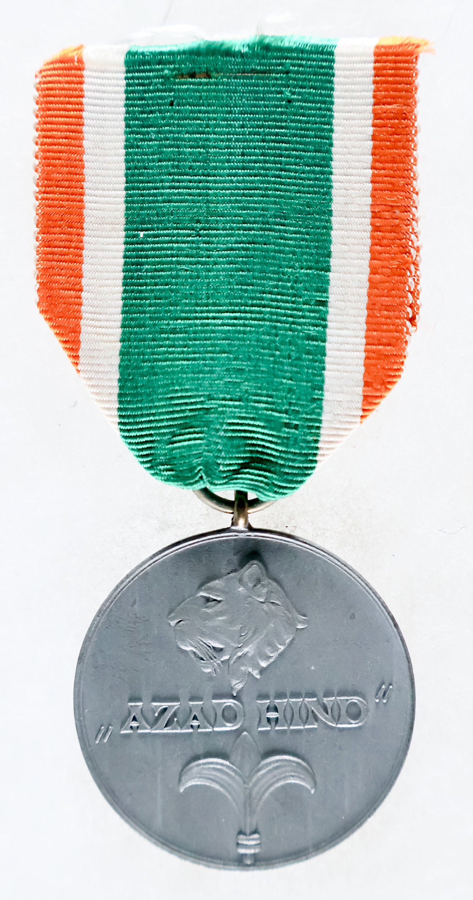 ORDER OF AZAD HIND MEDAL: A rare Order of Azad Hind medal called the ‘’ (‘Martyr of India’), measuring 1.5 in. dia. with a 1.75 in. Indian tricolor ribbon. The Azad Hind decorations were instituted by S