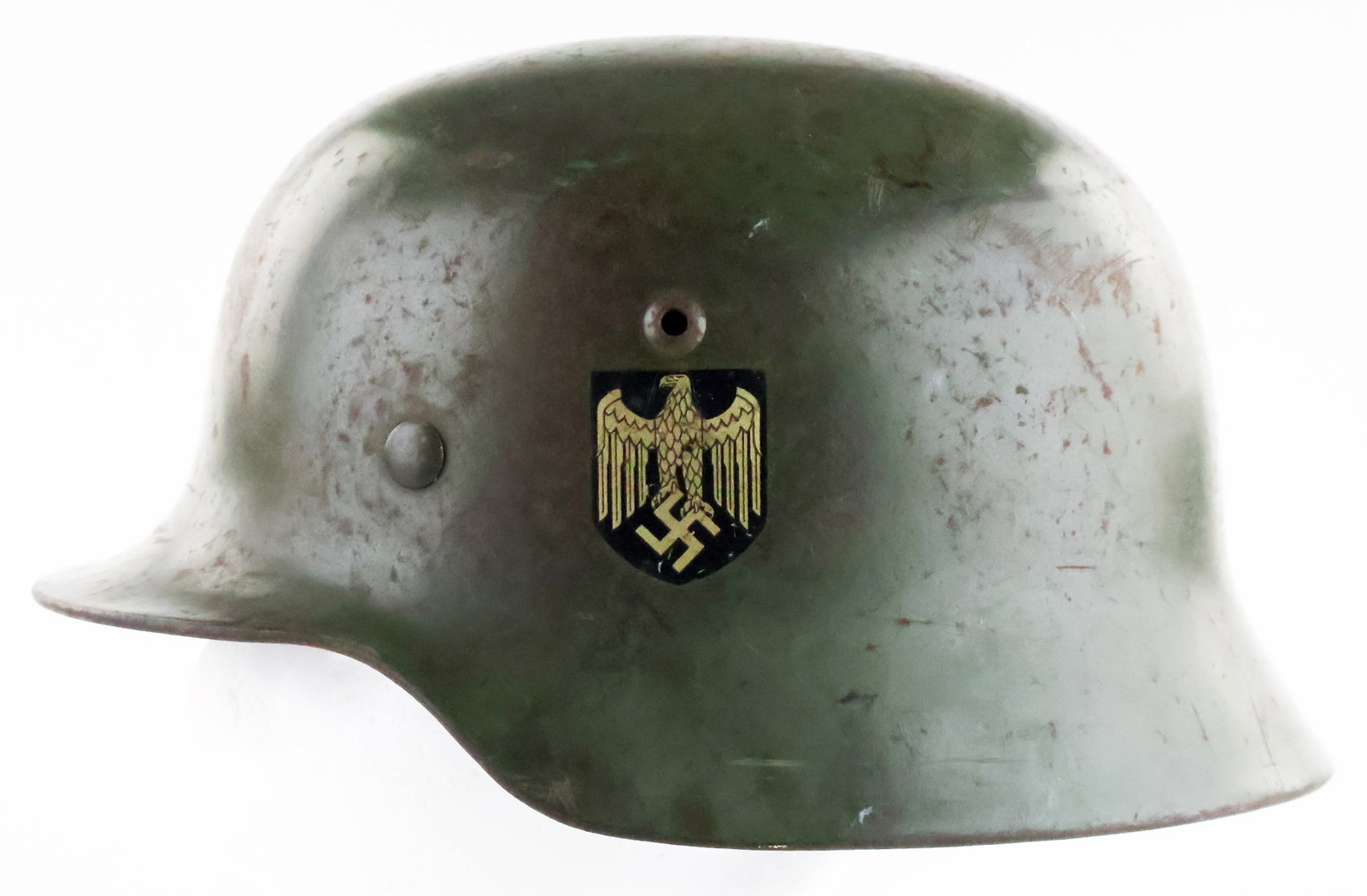 GERMAN M35 DOUBLE-DECAL HELMET: An exceptional German M35 double-decal helmet in the original green, the paint somewhat dulled and moderately chipped and some spots of rust showing in areas of moderate wear. The helmet retains the o