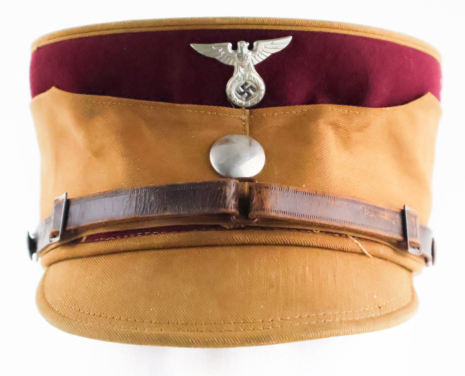 GRUPPE WESTFALEN S.A. KEPI: S.A. kepi once owned and worn by a member of the S.A. Gruppe Westfalen, brown twill body with burgundy trim at top, silver button and correct S.A. cap eagle affixed at front. Original leather chin str