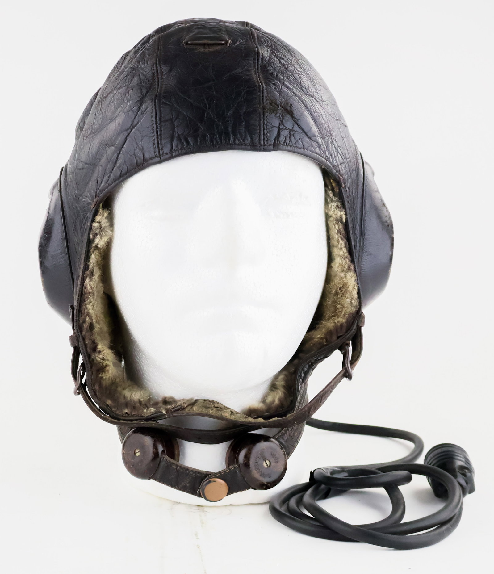 LUFTWAFFE LKPW101 WINTER HELMET: An intact and attractive Luftwaffe LKPW101 Fliegerkopfhaube for winter. The helmet is lined in both sheepskin and rabbit skin and includes the original tag which has a large stain obscuring most of th