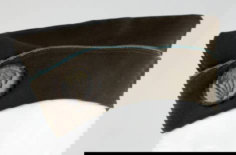 AMERICAN AIRBORNE DIVISION CAP: A wool cap with a blue lining and a parachute patch, indicating that the wearer was a paratrooper. The interior has a blue lining and the original leather sweatband.